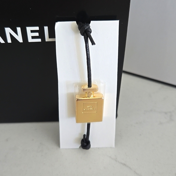 Brand new never used CHANEL bracelet gold bottle charm N°5 adjustable black cord - Picture 1 of 6